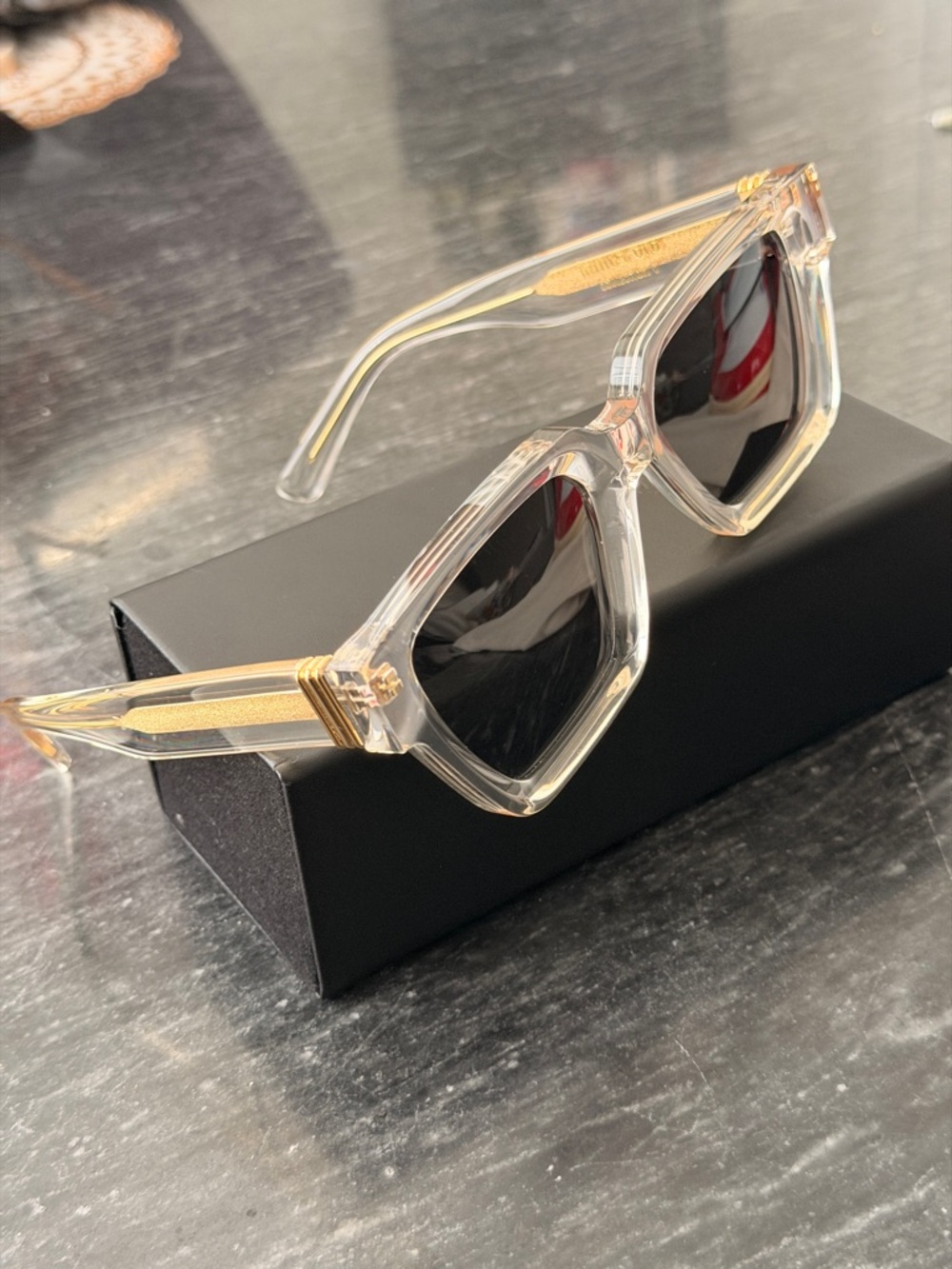 James Oro Clear Frame Sunglasses with Gold Accents and Black Lenses